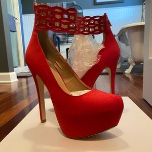 Red stiletto platform pumps